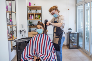 Hairstylist Blowing Drying Hair During COVID