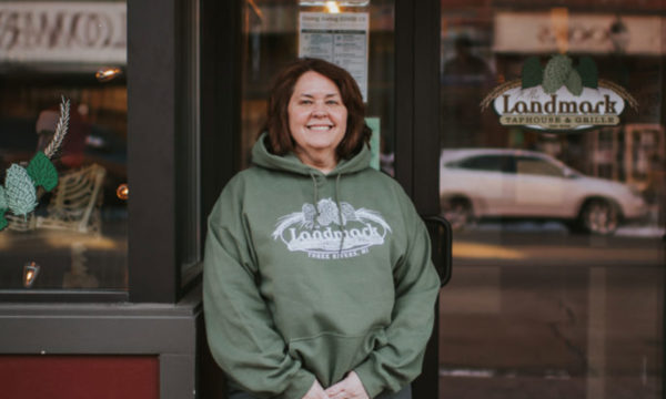 Landmark Taphouse & Grille owner smiling in front of building