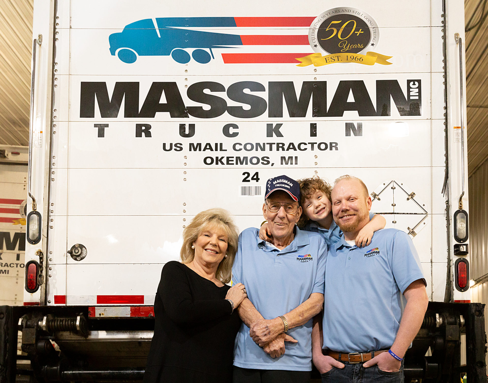 Massman Trucking family generation in front of truck