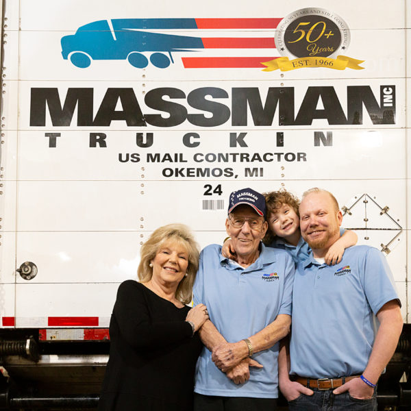 Massman Trucking family generation in front of truck