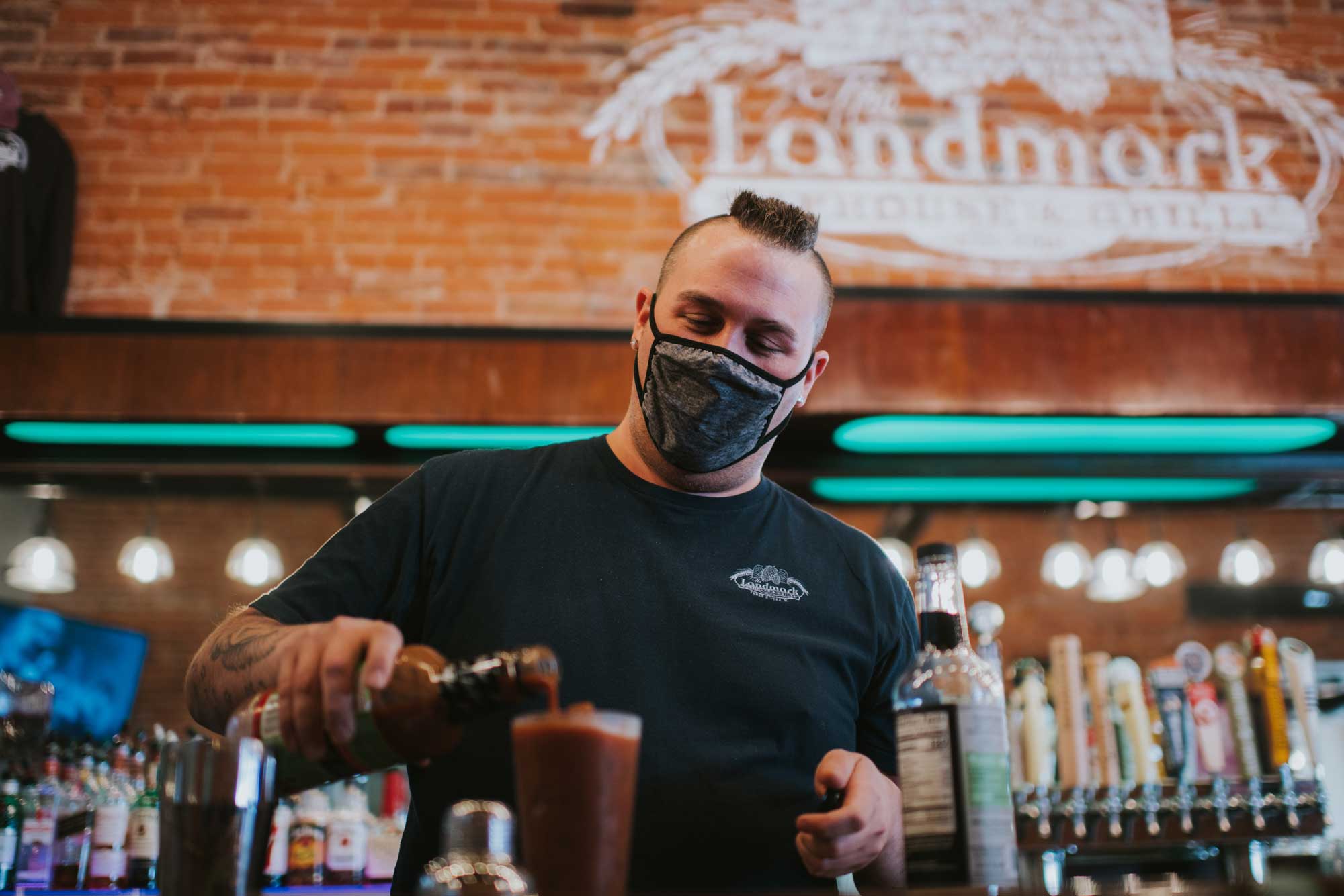 Landmark Taphouse and Grille bartender pouring a drink